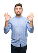 © Krakenimages.com - Young handsome man over isolated background relax and smiling with eyes closed doing meditation gesture with fingers. Yoga concept.