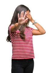 Poster - Young beautiful arab woman over isolated background covering eyes with hands and doing stop gesture with sad and fear expression. Embarrassed and negative concept.