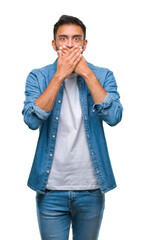 Canvas Print - Adult hispanic man over isolated background shocked covering mouth with hands for mistake. Secret concept.