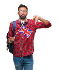 Poster - Adult hispanic student man holding passport of united kingdom over isolated background with angry face, negative sign showing dislike with thumbs down, rejection concept