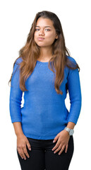 Sticker - Young beautiful brunette woman wearing blue sweater over isolated background puffing cheeks with funny face. Mouth inflated with air, crazy expression.