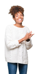 Beautiful young african american woman wearing winter sweater over isolated background Clapping and applauding happy and joyful, smiling proud hands together