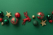 Christmas Decorations Concept. Top View Photo Of Reindeer Star Ornaments Gold Green And Red Baubles On Isolated Green Background