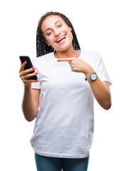 Poster - Young braided hair african american girl showing using smartphone over isolated background very happy pointing with hand and finger