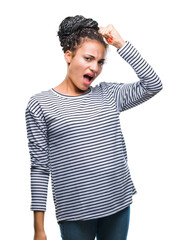 Sticker - Young braided hair african american girl wearing sweater over isolated background angry and mad raising fist frustrated and furious while shouting with anger. Rage and aggressive concept.