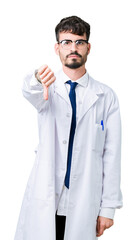 Sticker - Young professional scientist man wearing white coat over isolated background looking unhappy and angry showing rejection and negative with thumbs down gesture. Bad expression.