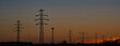 © Adam Rajsz - High Voltage Electricity Poles and wires on the sunset and blue sky
