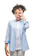 © Krakenimages.com - Young afro american woman over isolated background doing ok gesture shocked with surprised face, eye looking through fingers. Unbelieving expression.