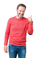 Wall Mural - Handsome middle age hoary senior man wearing winter sweater over isolated background doing happy thumbs up gesture with hand. Approving expression looking at the camera showing success.