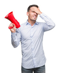 Canvas Print - Handsome young man holding microphone stressed with hand on head, shocked with shame and surprise face, angry and frustrated. Fear and upset for mistake.