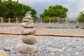 Pebble pyramid. Travel symbol. Background with copy space