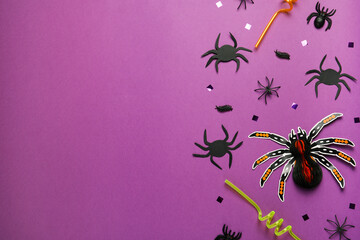 Wall Mural - Flat lay composition with spiders, confetti and straws on purple background, space for text. Halloween celebration