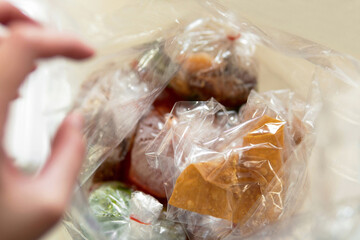 close-up Looking into food in a single use takeout transparent plastic bag