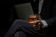 © maeching - Closeup businessmen holding a glass of whiskey