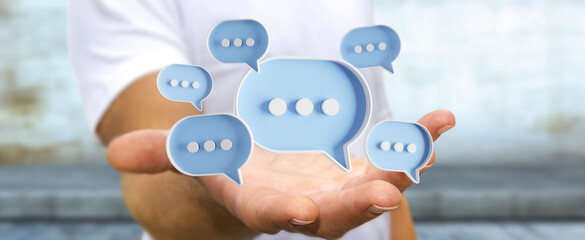 Wall Mural - Man touching with his fingers digital speech bubbles talk icons. Minimal conversation or social media messages floating in front of businessman hand. 3D rendering