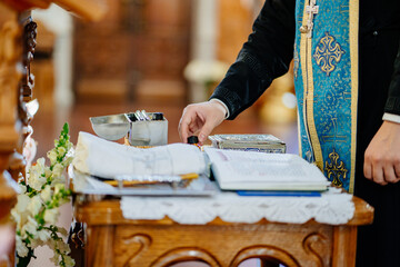 Canvas Print - priest with baptismal items in Orthodox Church.