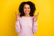 © Tetiana - Photo of young brutal woman careless show fingers rock horns sign isolated over yellow color background