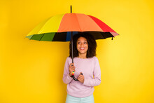Photo Of Young Cheerful Lady Hold Umbrella Rainy Weather Spring Isolated Over Yellow Color Background