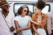 Travel, friends and car road trip, holiday or summer vacation adventure spending outdoors time together. Smile, happy and black people laughing, bonding or having fun enjoying conversation or talk.
