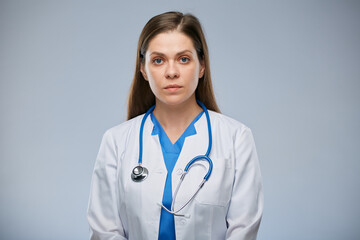 Wall Mural - Serious doctor woman with stethoscope. Isolated portrait of female medical worker