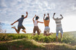 © S Fanti/peopleimages.com - Friends, nature and jumping for freedom in the countryside for summer vacation together in the outdoors. Group of free people enjoying holiday break or travel in joyful fun outside in South Africa