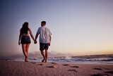 Fototapeta Sport - Couple, holding hands and love for beach walk together in romantic summer sunset in the outdoors. Hand hold of man and woman walking on a beautiful ocean coast in romance for vacation in Costa Rica