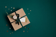 Christmas Background With Gift Box Wrapped In Kraft Paper. Xmas Celebration, Preparation For Winter Holidays. Festive Mockup, Top View, Flat Lay In Natural Colos