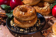 Traditional tasty ready to eat apple cider donuts. Homemade baked apple cinnamon donuts with apple pie crumble and spices, served on wooden table copy space