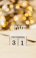 Wall Mural - Wooden calendar with the inscription December 31 on the background of Christmas lights