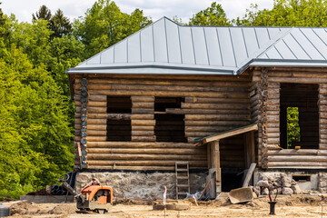 Poster - unfinished wooden house outside the city