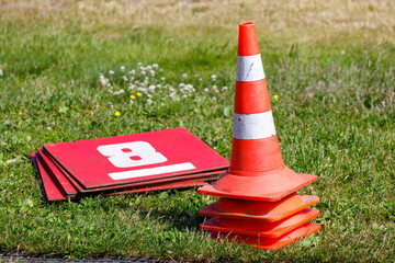 Aufkleber - barriers cones with signs lie on the grass of the stadium