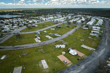 Severely Damaged And Overturned Camper Vans And Houses After Hurricane Ian In Florida Mobile Home Residential Area. Consequences Of Natural Disaster