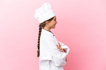 Sticker - Little caucasian chef girl isolated on pink background in lateral position