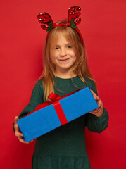 Wall Mural - Smiling funny child (kid, girl) in Reindeer Hairband