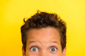 Cropped closeup photo of half face impressed schoolchild big eyes look isolated on yellow color background