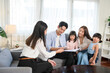 © tonefotografia - Asian family meeting with female real estate agent or insurance consultant offering promotions , Mortgage, loan, property and medical health insurance concept.