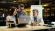 © Framestock - Multi-ethnic team of creative workers discussing business strategy or startup project in modern office using laptop. E-commerce company. Work on startup project