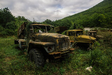 Old Abandoned Rusty Military Trucks Overgrown By Plants