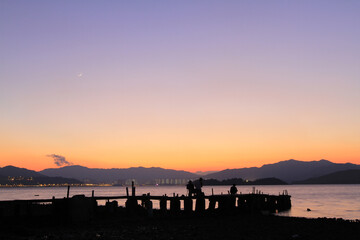 Wall Mural - a Sunset on a rocky beach in Hong Kong.