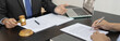 © Puwasit Inyavileart - Lawyer or judge has recommend a client sign a legal agreement in the courtroom, Legal Agreement Documents and Business Litigation Forms, scales of justice, law hammer, Litigation and legal services.