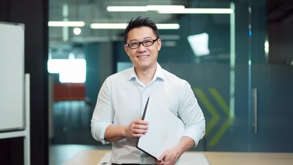 portrait of young asian man specialist, employee programmer or teacher standing in modern office or 