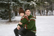 © Studio Peace - Joyful father and son are having fun in the winter forest in knitted sweaters and hats