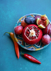 Canvas Print - Colorful still life with fresh fruit. Pomegranate close up photo. Israeli food on a table. Eating fresh concept. 