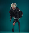 © qunica.com - Male beauty concept. Portrait of fashionable young man with stylish haircut wearing trendy glasses and sweater, posing over gray background. Perfect hair & skin. Hipster style. Copy-space. Studio shot