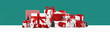 Big pile of assorted red and white gift boxes and ornaments with Christmas trees on blue green background. Assorted size. Merry Christmas and Happy New Year gift shopping and sale concept