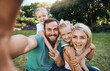 © Clement C/peopleimages.com - Nature, selfie and portrait of a happy family on a picnic together in outdoor green garden. Happy, smile and parents playing, hugging and bonding with children outside in backyard or park in canada.