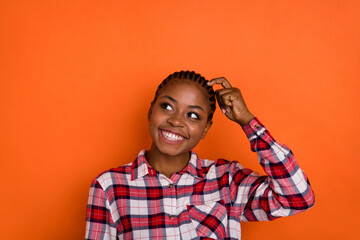 Wall Mural - Photo of dreamy funny woman dressed plaid shirt looking empty space forget important thing isolated shine vibrant orange color background