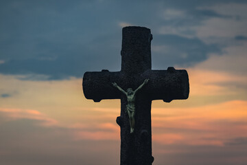 Canvas Print - Stone cross on a grave during sunset in Poland