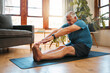 © N Lawrenson/peopleimages.com - Health, exercise and yoga with senior man doing ground stretching before meditation and wellness workout. Fitness, relax and floor warm up by elderly male start healthy cardio training in living room