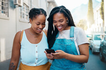 Happy Black Woman, Friends And Phone In Social Media Communication, Texting Together Outside An Urban Street. African Women Smiling For 5G Connection In Canada Browsing, Chatting On Mobile Smartphone